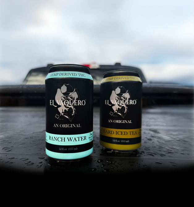 Two cans of El Aquero ranch water and iced tea on a wet surface with a blurred background.